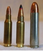 Photo of the 5.7x28mm cartridge next to the similarly-sized 4.6x30mm and .30 carbine cartridges